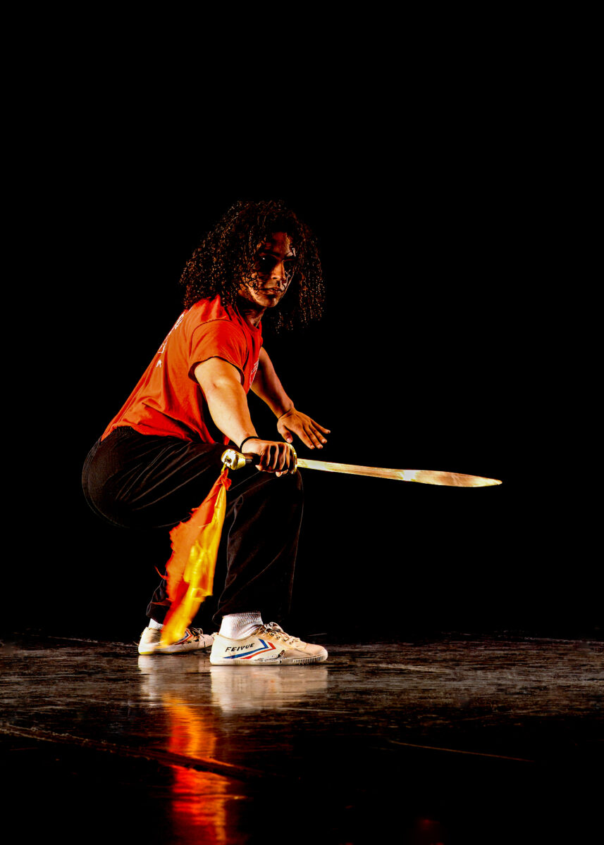 Young man at Kung Fu demonstration with sword